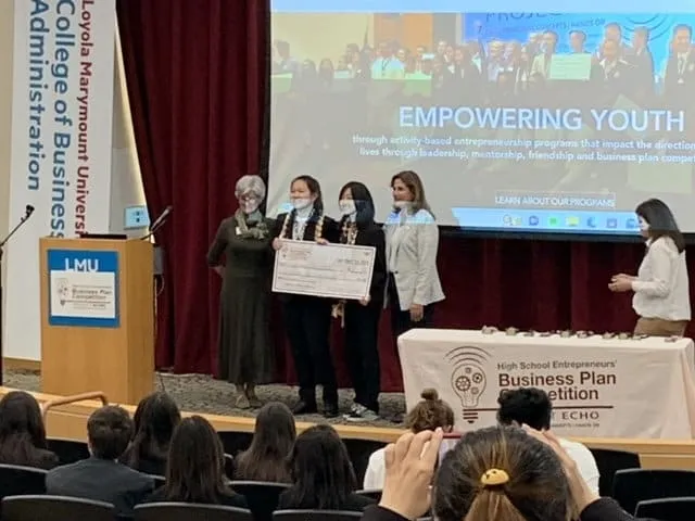 A Polaris student team receives an award on stage at Loyola Marymount University.